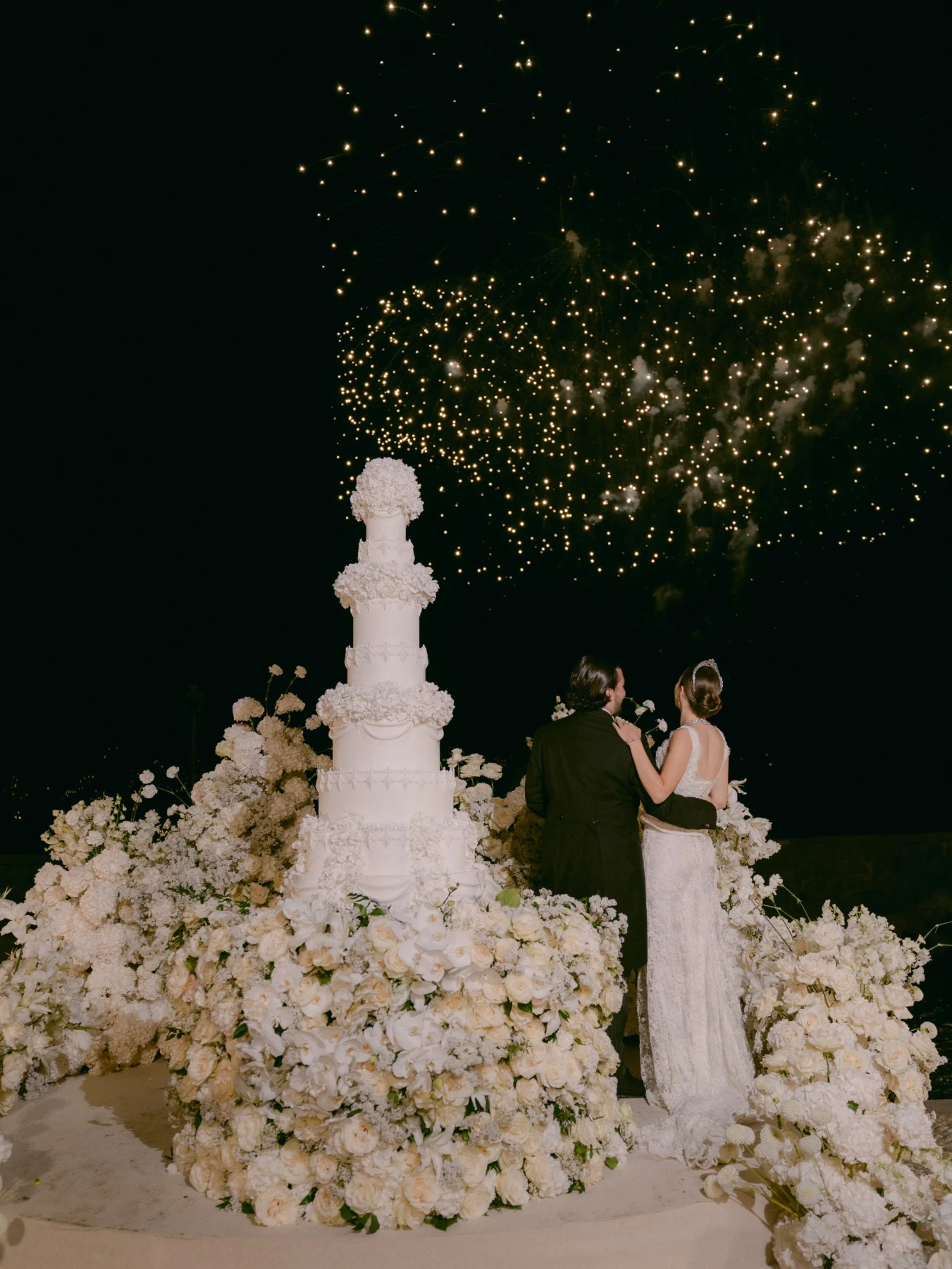 Wedding cake surrounded by white flowers